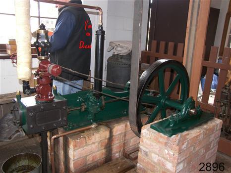 View shows the belts attached to the wheel that is driven by the engine