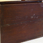Narrow, wide timber box with hinged flip top lid and dowel around the base as extra support