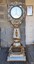 Upright metal scale with round face, coil slot and weighing platform