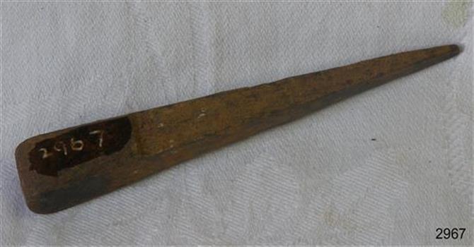 Wedge shaped metal tool with flat sides and top, and a narrow flat end