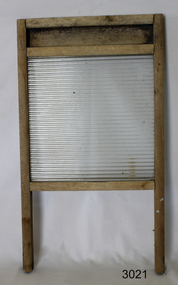 Washboard with wooden frame, ribbed glass centre and two legs