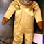 A yellow coloured diving suit with helmet and heavy weight boots. Weight has a buckle and fixing ring on the front.