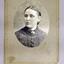 Rectangular card with oval frame matte around the portrait of a woman