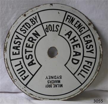 Metal dial painted white with black inscriptions for direction and speed