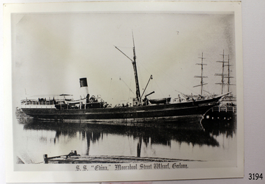 Rectangular black and white photograph of a steam ship