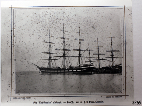 Black and white photograph of sailing ship ships docked with bare masts