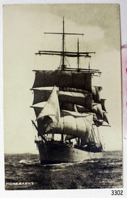 Image of sailing ship in full rig at sea, black and white, bow at front facing slightly left