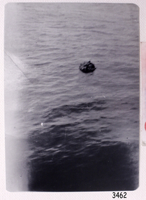 Black and white photograph, figures in a lifeboat, viewed from a distance