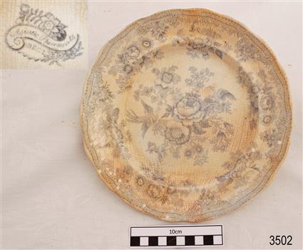 White ceramic plate with blue floral pattern and scalloped edges