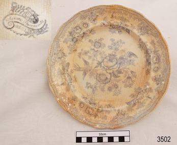 White ceramic plate with blue floral pattern and scalloped edges