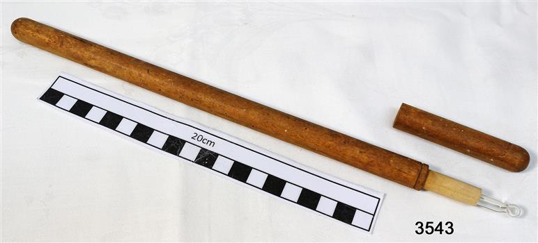A long glass thermometer with mercury bulb, inside a lightweight wooden cylinder with top