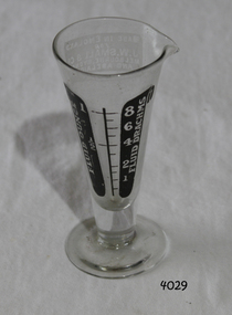Clear glass, sides slope inwards towards narrow base. Measurements and text in black.