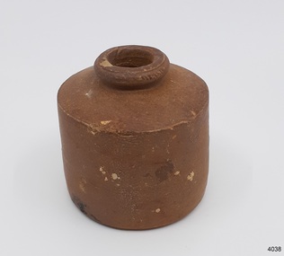 Brown clay bottle with short neck, broad shoulders and straight sides