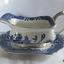 Blue and white patterned gravy boat resting on a matching saucer