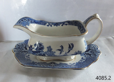 Blue and white patterned gravy boat resting on a matching saucer