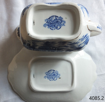 Blue stamps showing maker's marks on underside of boat and saucer