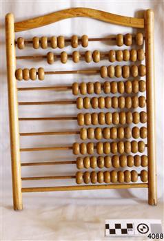 An wooden abacus with ten rows of wooden beads, each ro containing ten beads.