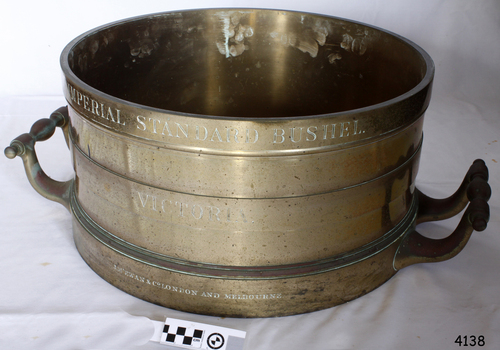 Brass cylinder with two handles and engraved text