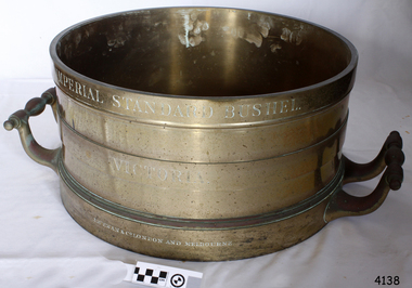 Brass cylinder with two handles and engraved text