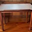 Wooden desk with sloping top and pencil ledge across the front