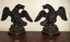 Iron bookends, cast and hollow, facing each other. Details include fairhers.