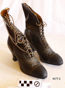 Ladies' brown leather calf length boots with lacing up to the top.