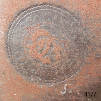 Label impressed into sole of boot, concentric circles with text between, logo in circle's centre