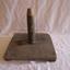 Wooden quoit base with vertical rod at centre.