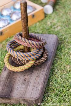 Colour photograph showing quoit base with six different woven quoits.