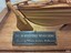 Rectangular black plaque with gold embossed details