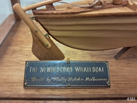 Rectangular black plaque with gold embossed details