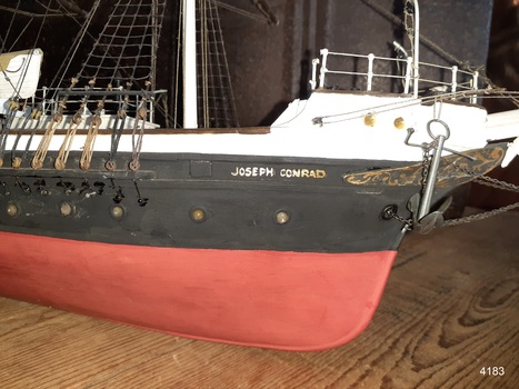 Ship's name is painted in gold capital letters