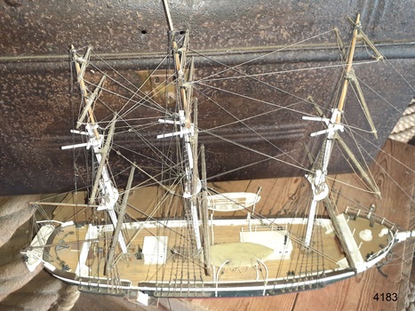 One lifeboat is covered, the other two are overboard, hanging, ready to use