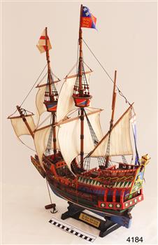 Wooden ship model with three masts and flying two flags