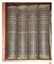 Four upright volumes bound in brown with gold embossed titles on the spine