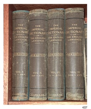 Four upright volumes bound in brown with gold embossed titles on the spine