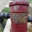 Maker's metal plate has manufacture and design details embossed on the metal, which is screwed onto the handle