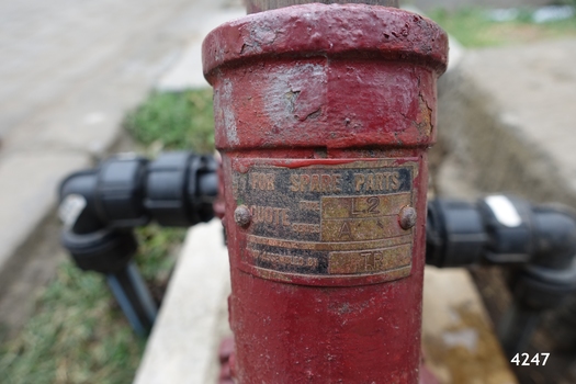 Maker's metal plate has manufacture and design details embossed on the metal, which is screwed onto the handle