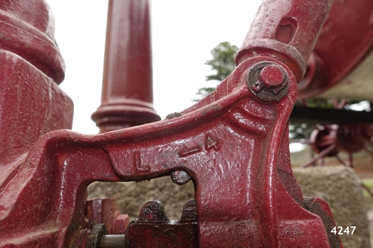 Details are cast into the metal, possibly representing the size or ratio of the mechanical movement