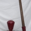 Crimson painted cast metal base with timber and metal lever and handle