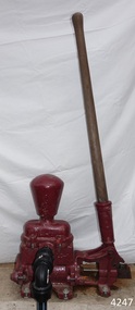 Crimson painted cast metal base with timber and metal lever and handle