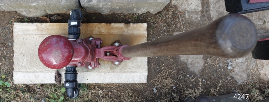 View shows the space within which the lever moves, mechanically pumping the water from the lake