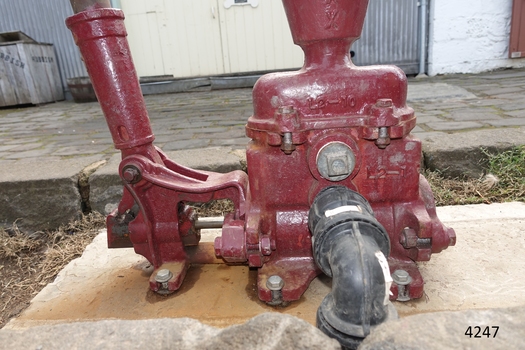 Cast metal base housing have embossed details in the metal. Sockets are visible, where pumping attachments can be added.