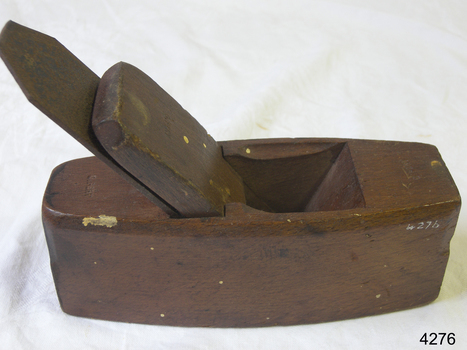 Wooden coffin-shaped tool with metal blade and blade-guide