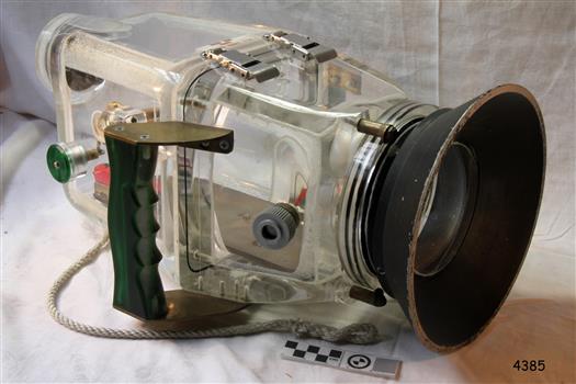 Clear camera housing with plastic and metal components and clip closure