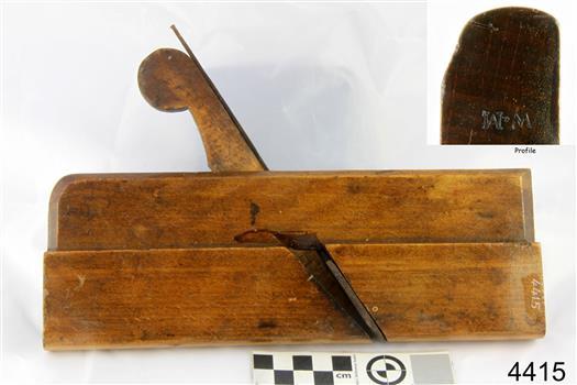 Wooden plane with metal blade inserted