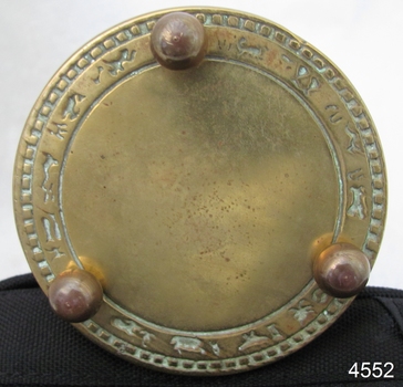 The underside has three round copper feet