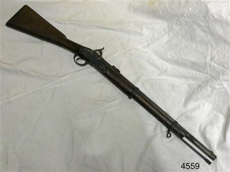 Metal and wood gun on a bench, viewed from above
