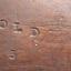 Figures and oval borders stamped on timber