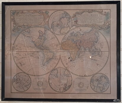 Dark brown wooden timer frame around coloured print of world map on beige paper. 